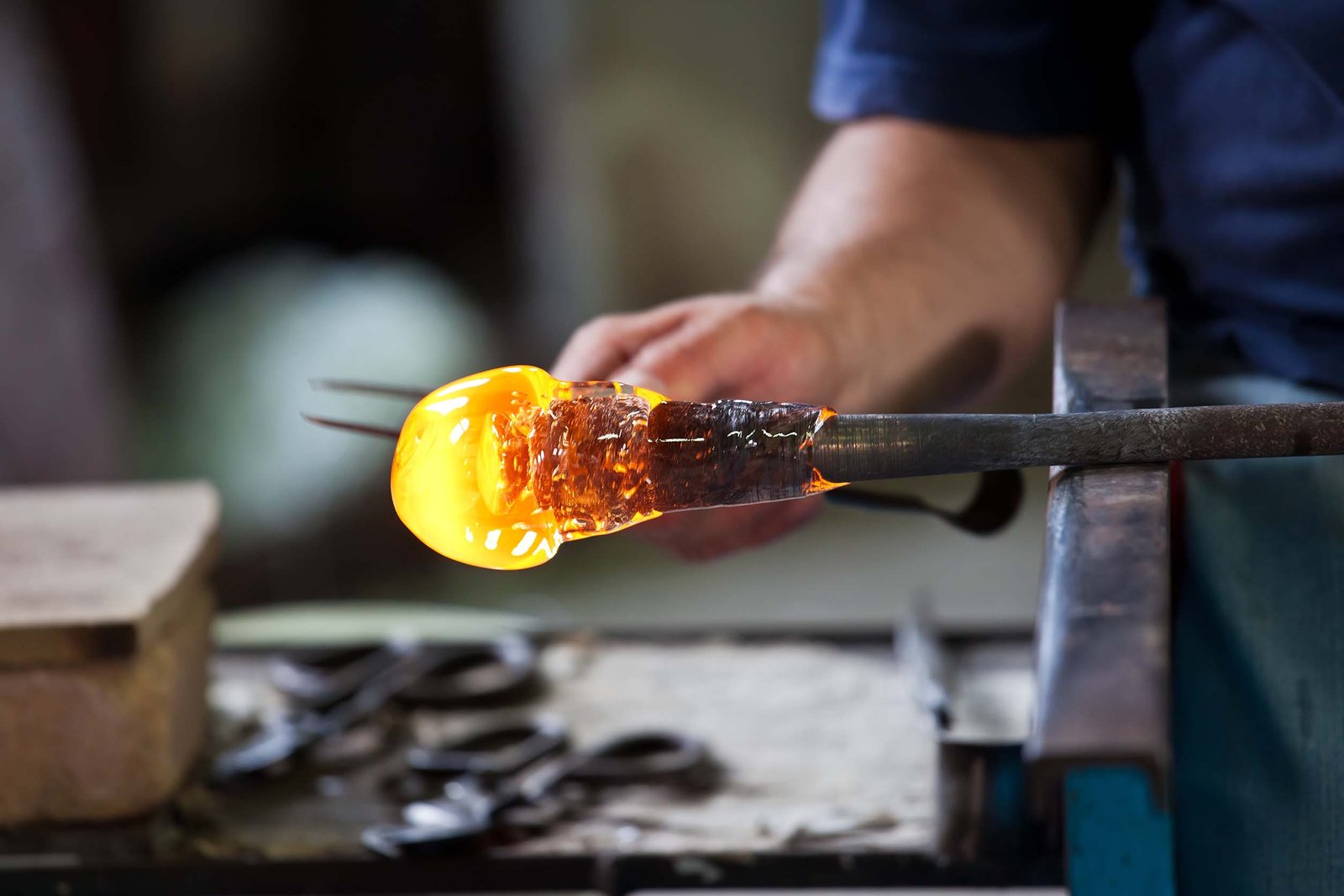 glass blower forming beautiful piece of glass, murano, venice, italy